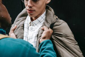 Black man grabbing classmate in college